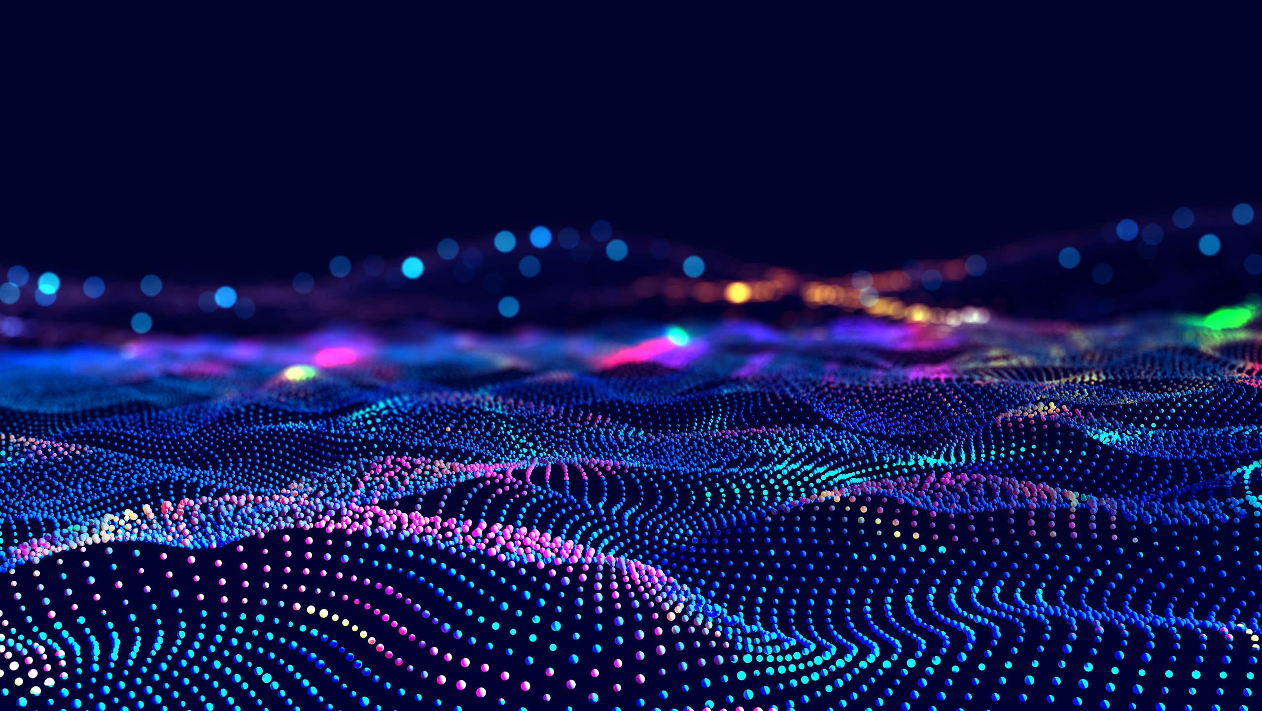 Abstract image of waves of coloured dots against a black background.
