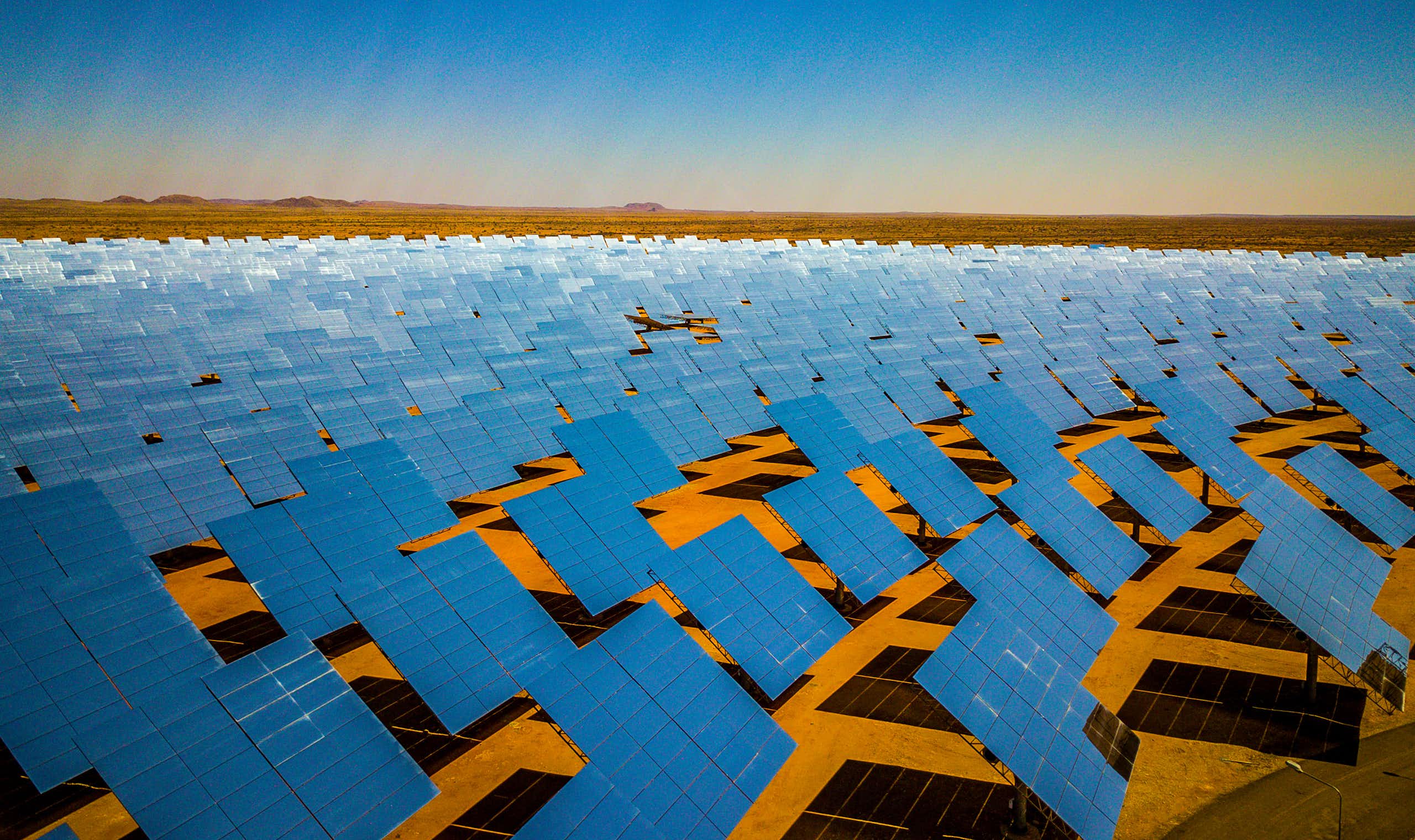 A giant array of solar panels spread out across the desert in South Africa's Northern Cape