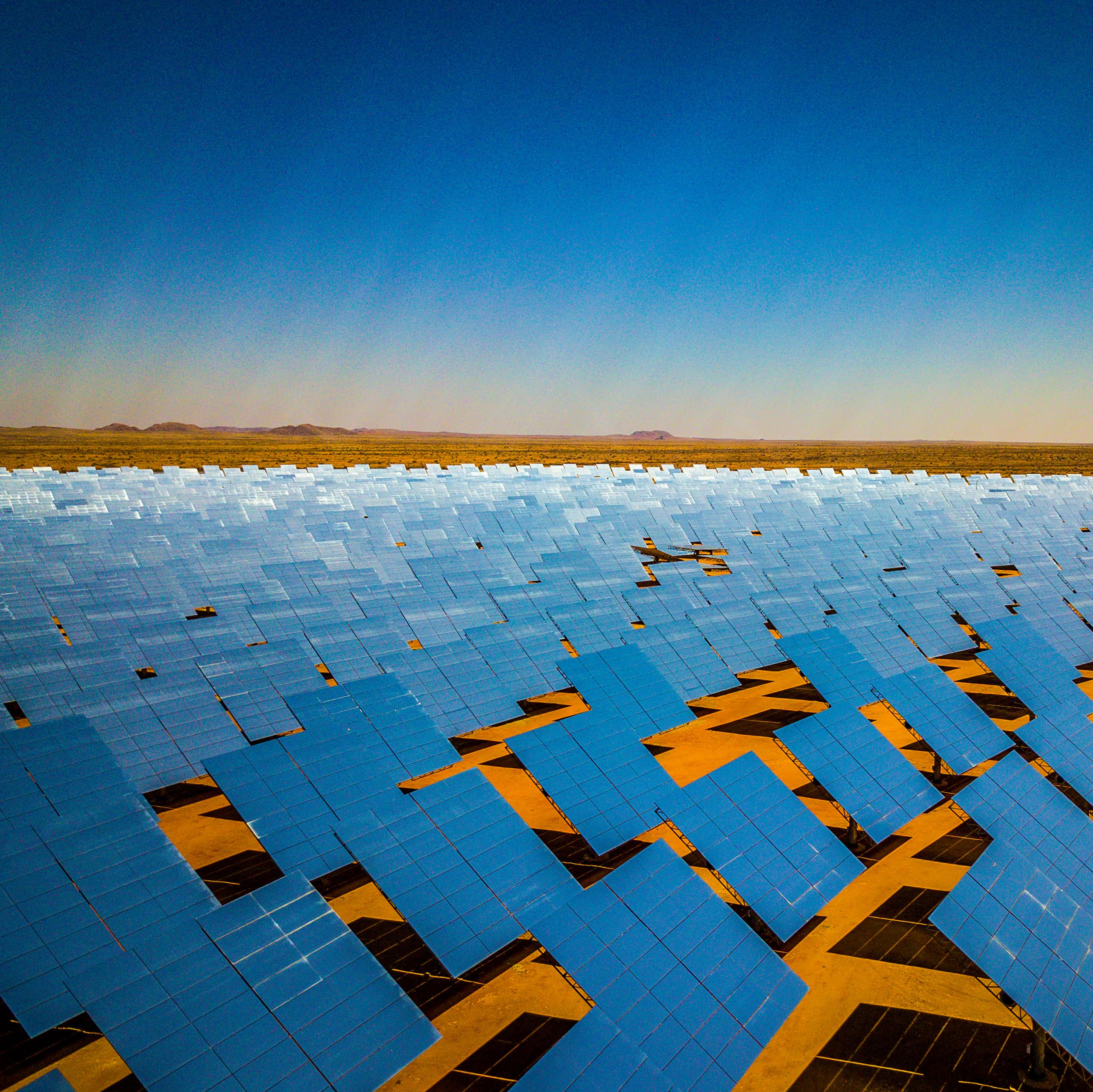 A giant array of solar panels spread out across the desert in South Africa's Northern Cape