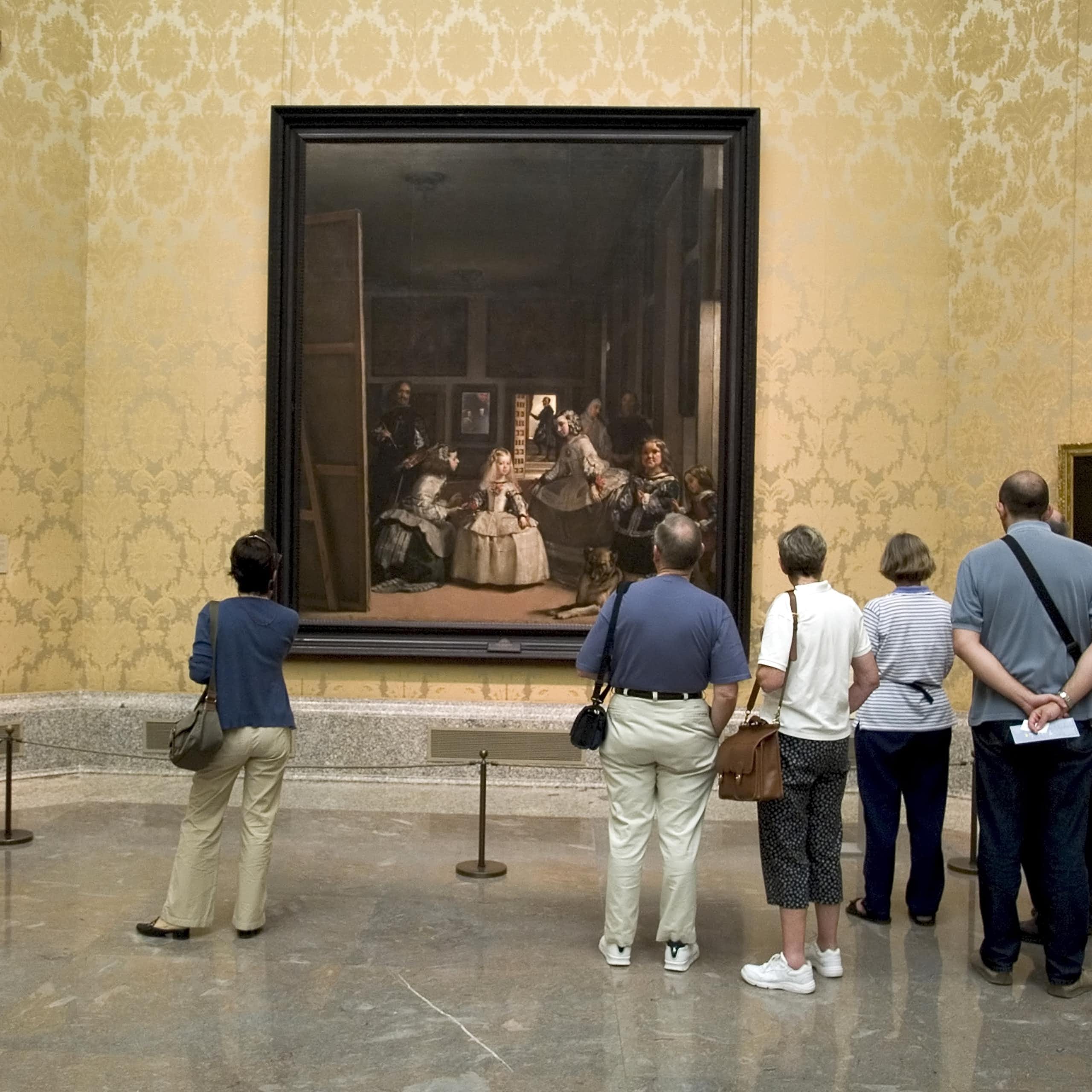 Vistors at the Prado Museum in Madrid look at Velázquez's painting 'Las Meninas'.