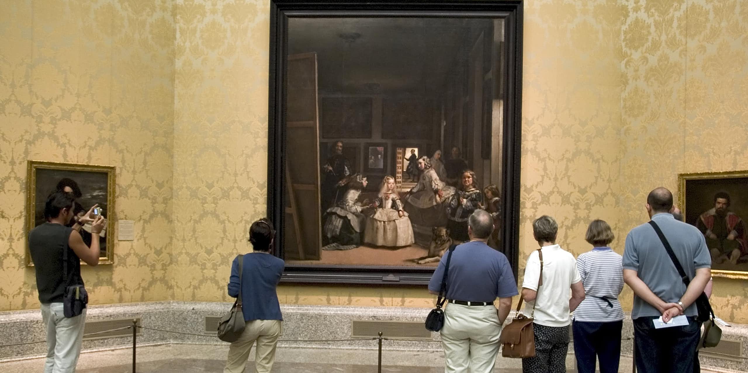 Vistors at the Prado Museum in Madrid look at Velázquez's painting 'Las Meninas'.