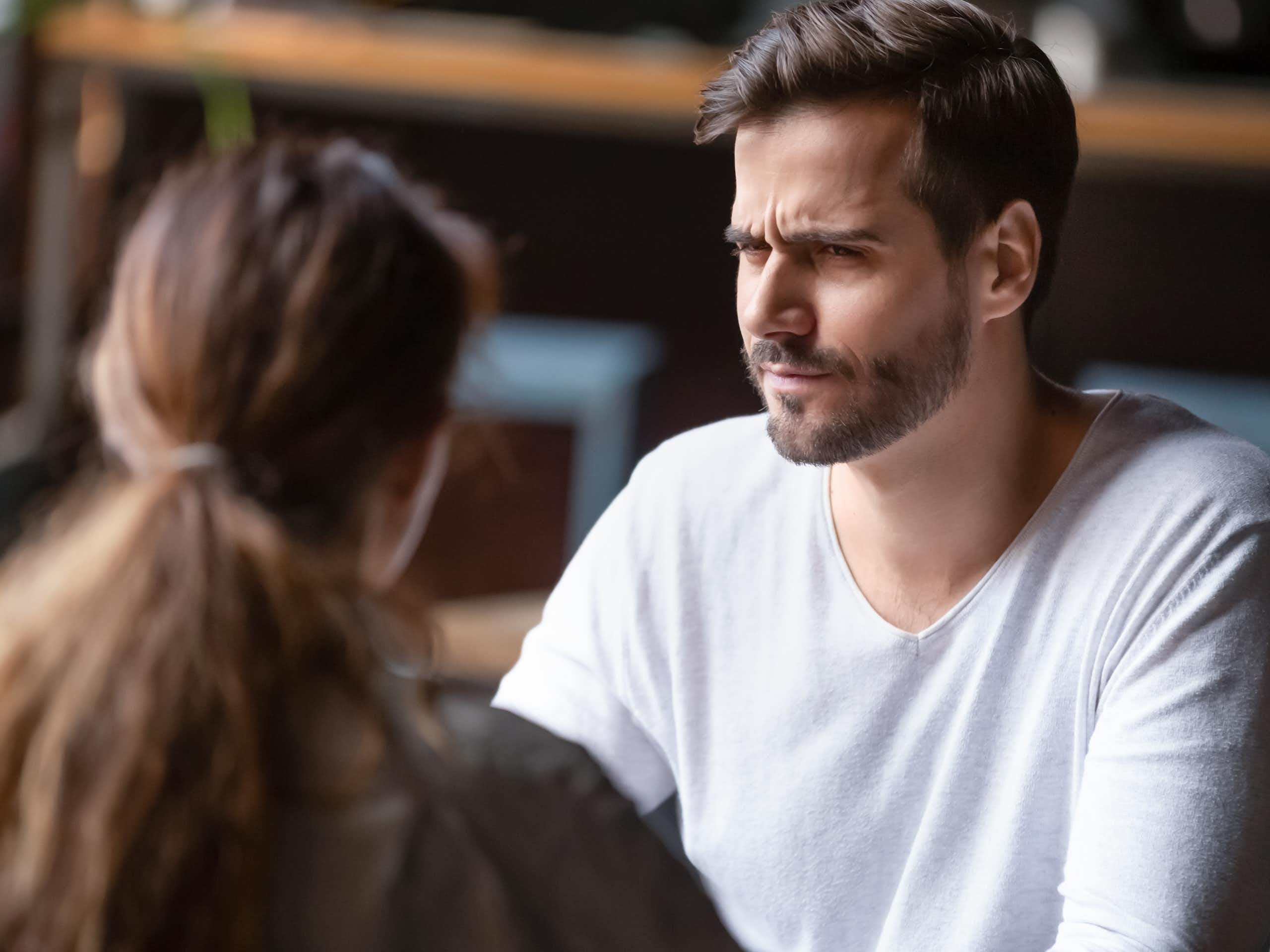 A man appears confused looking at a woman