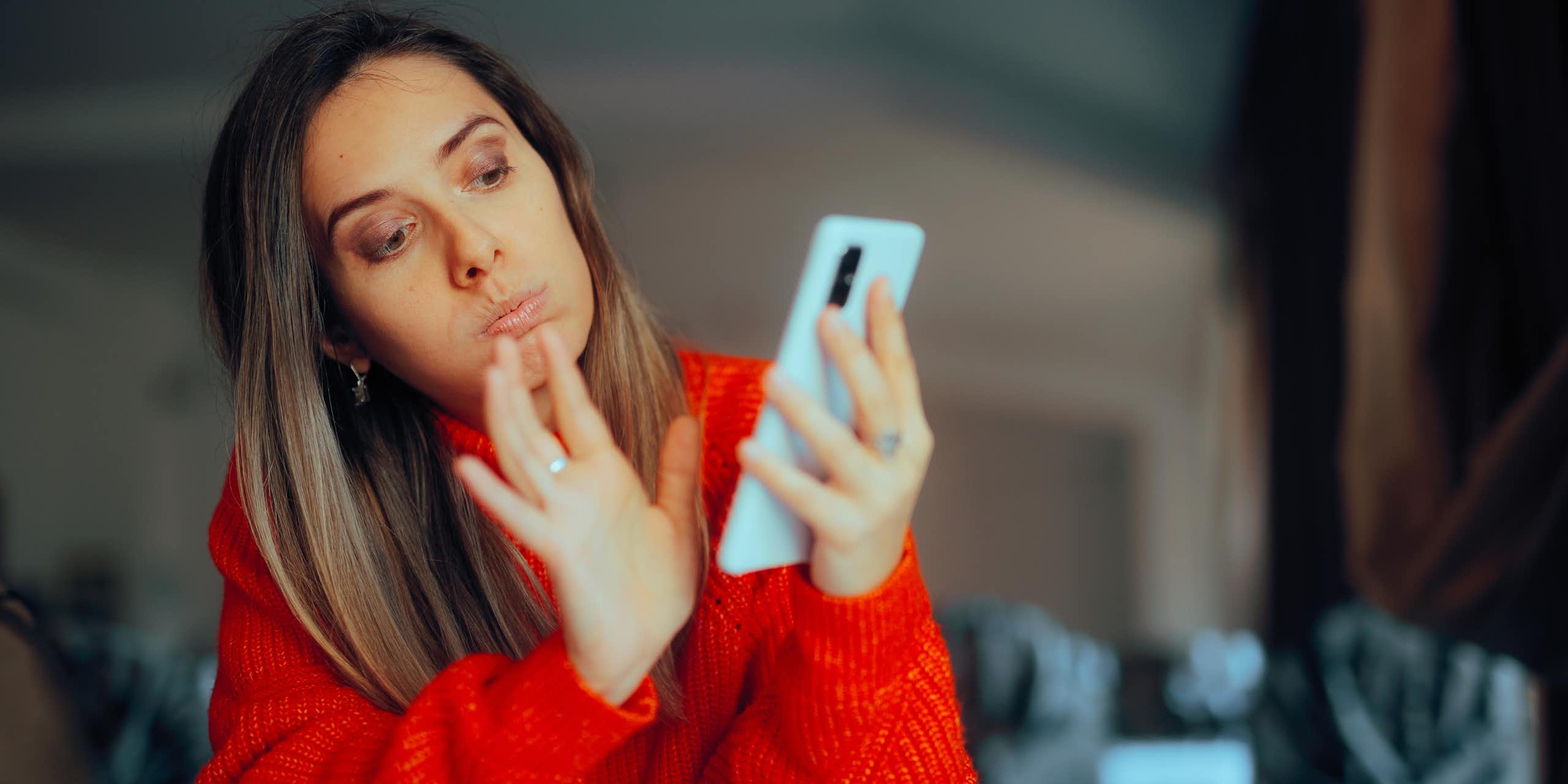 A woman swiping on her phone. 