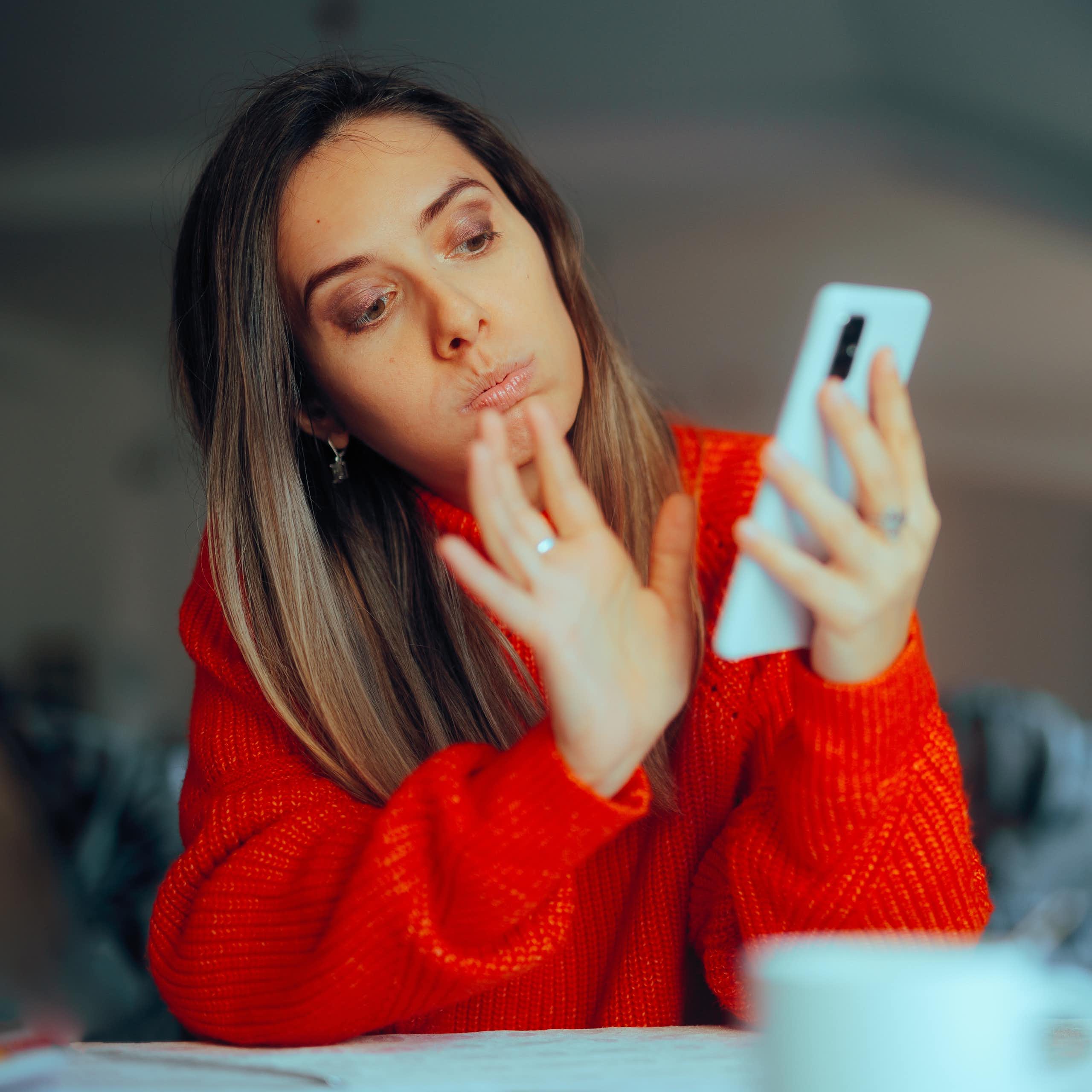 A woman swiping on her phone. 