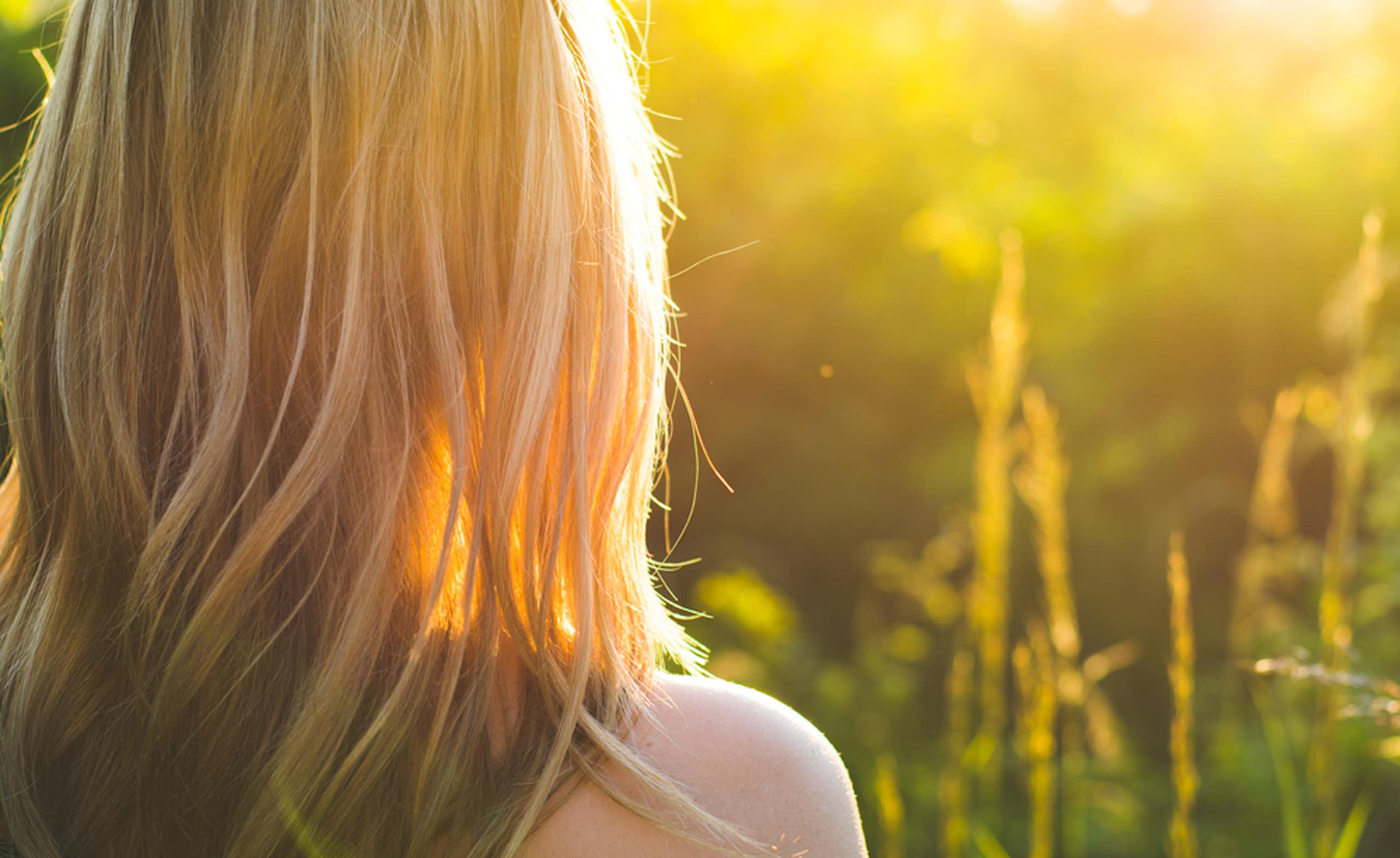 Person outside, facing the sunlight