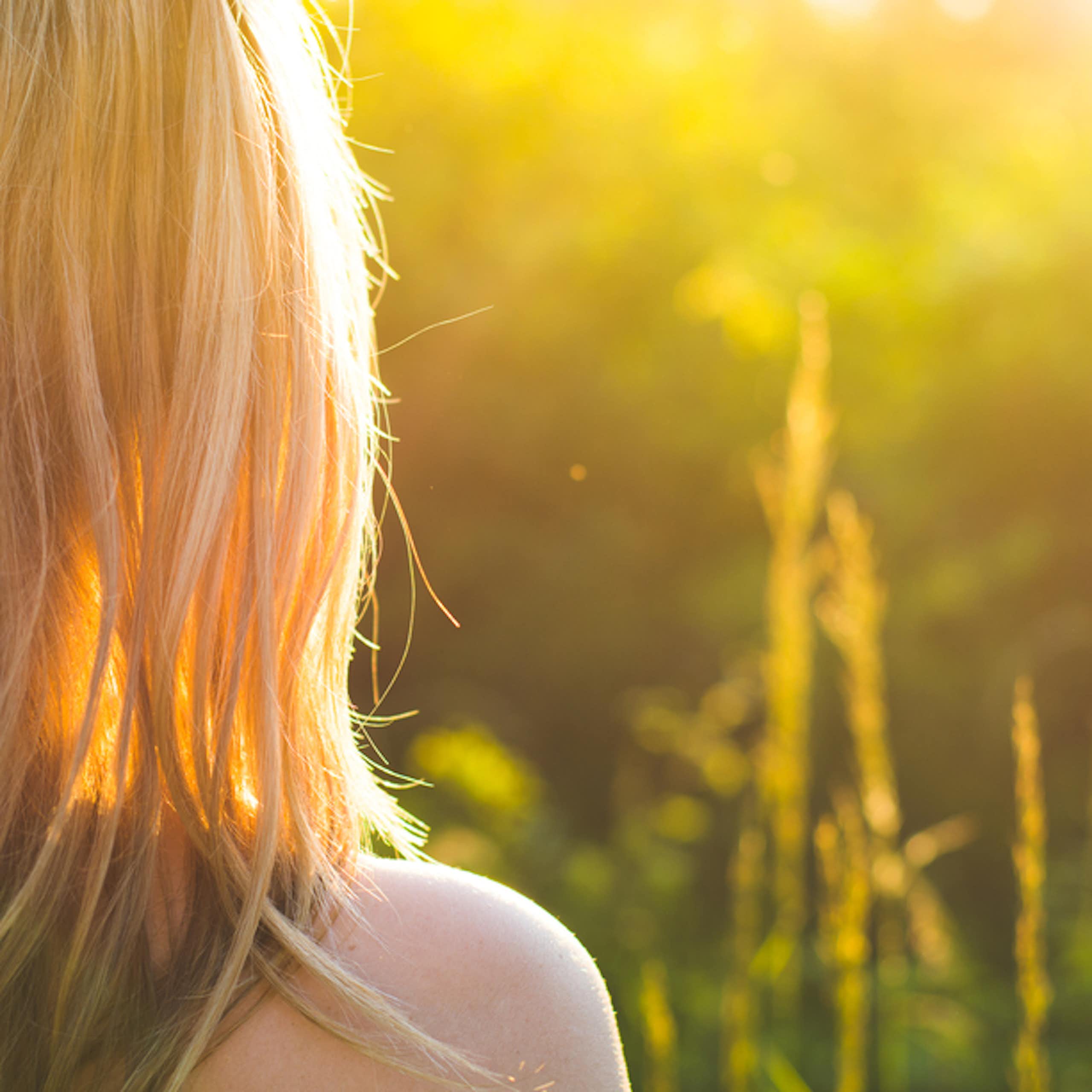 Person outside, facing the sunlight