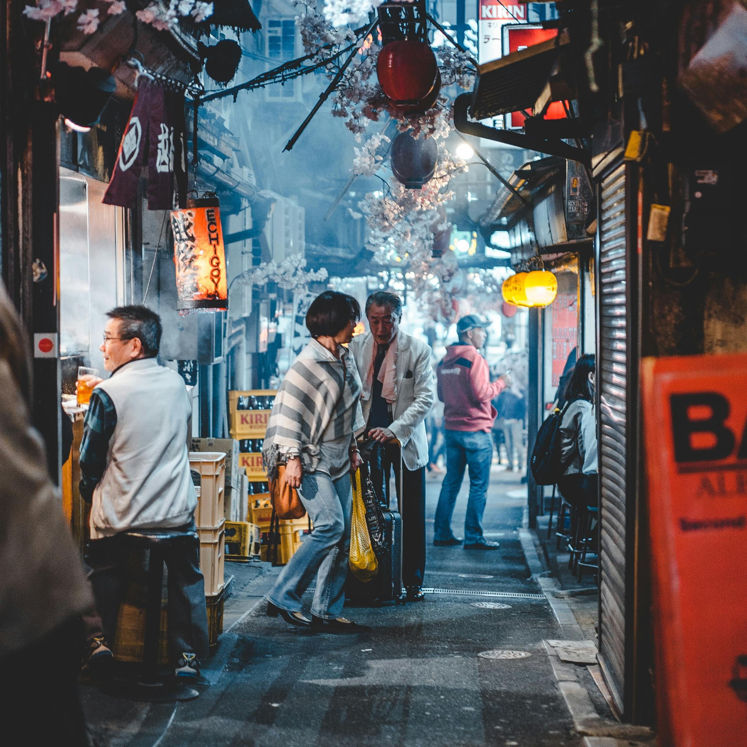 An older Japanese couple in a laneway.