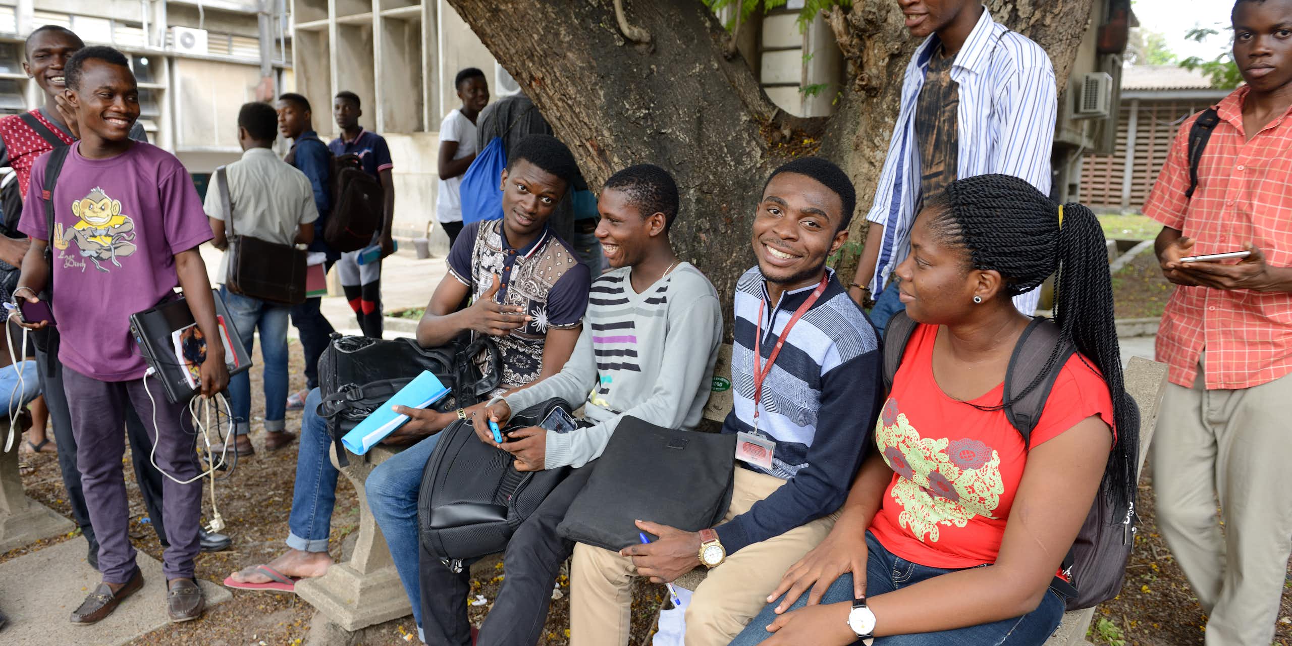 A group of people sitting under a tree