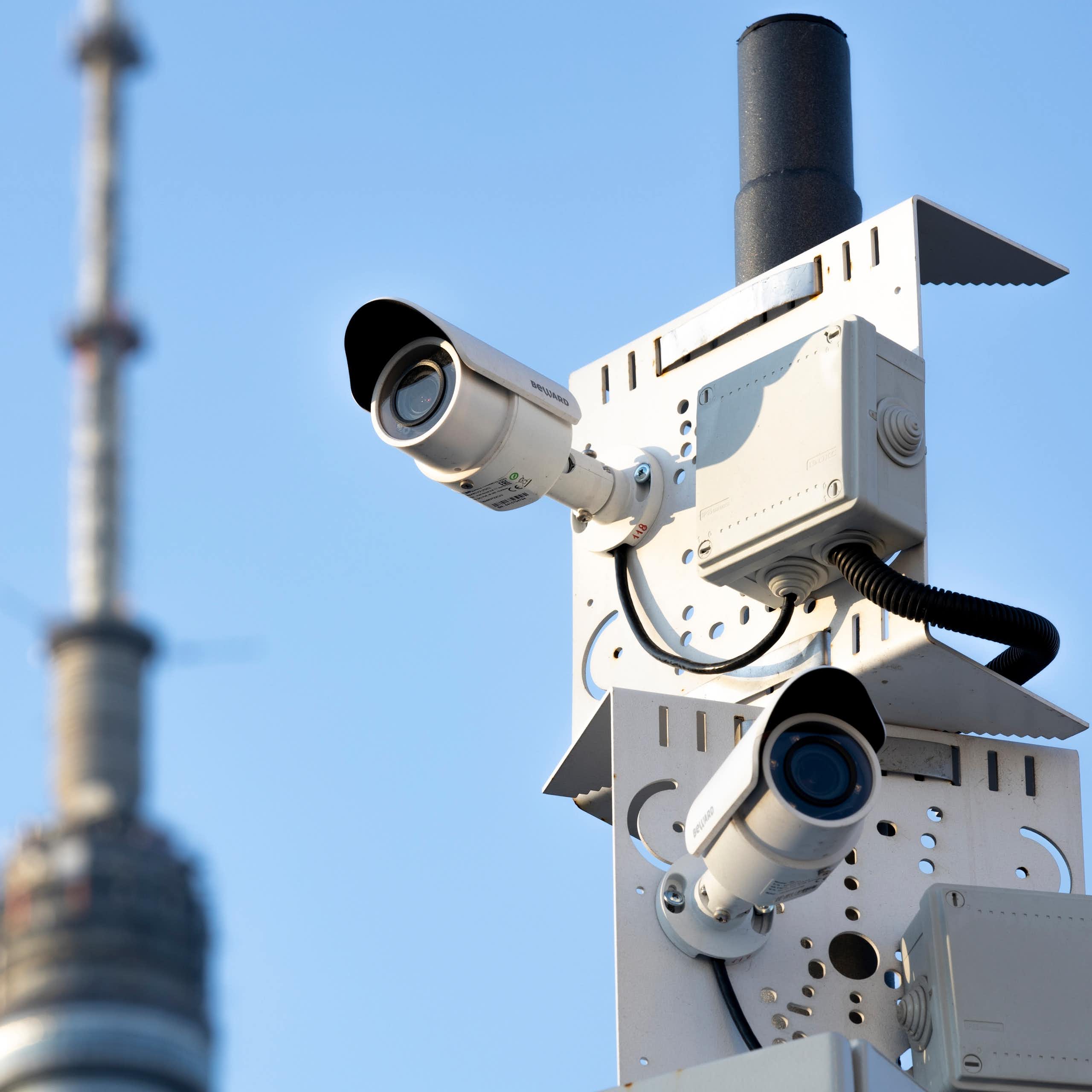 Two security cameras on a pole