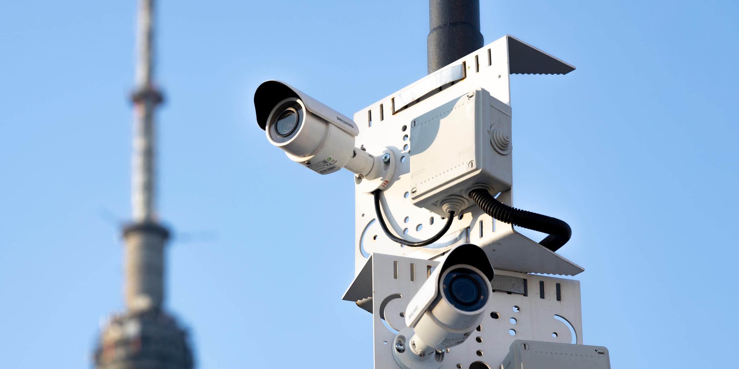Two security cameras on a pole