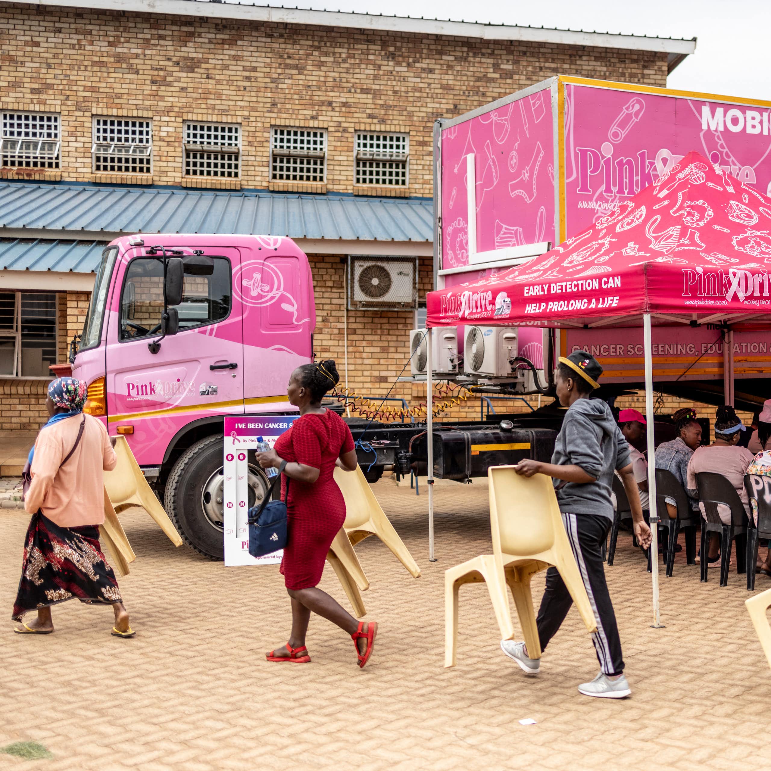 Patients and chairs during breast cancer screening drive 