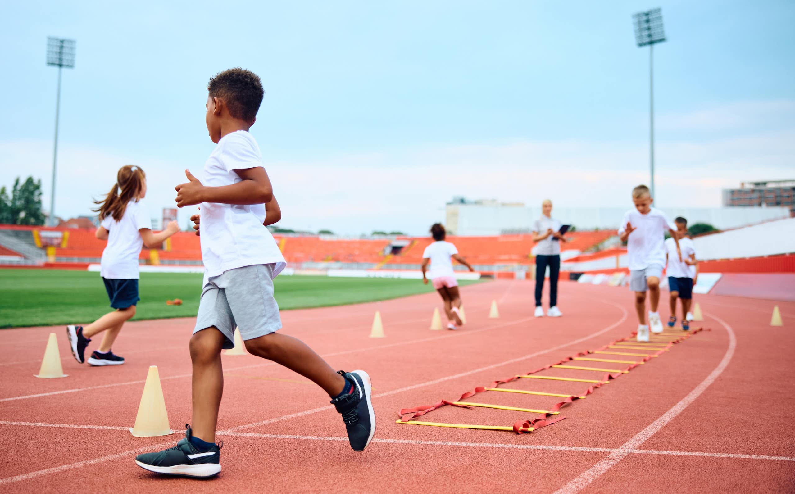 Children enjoy running games at an athletics track