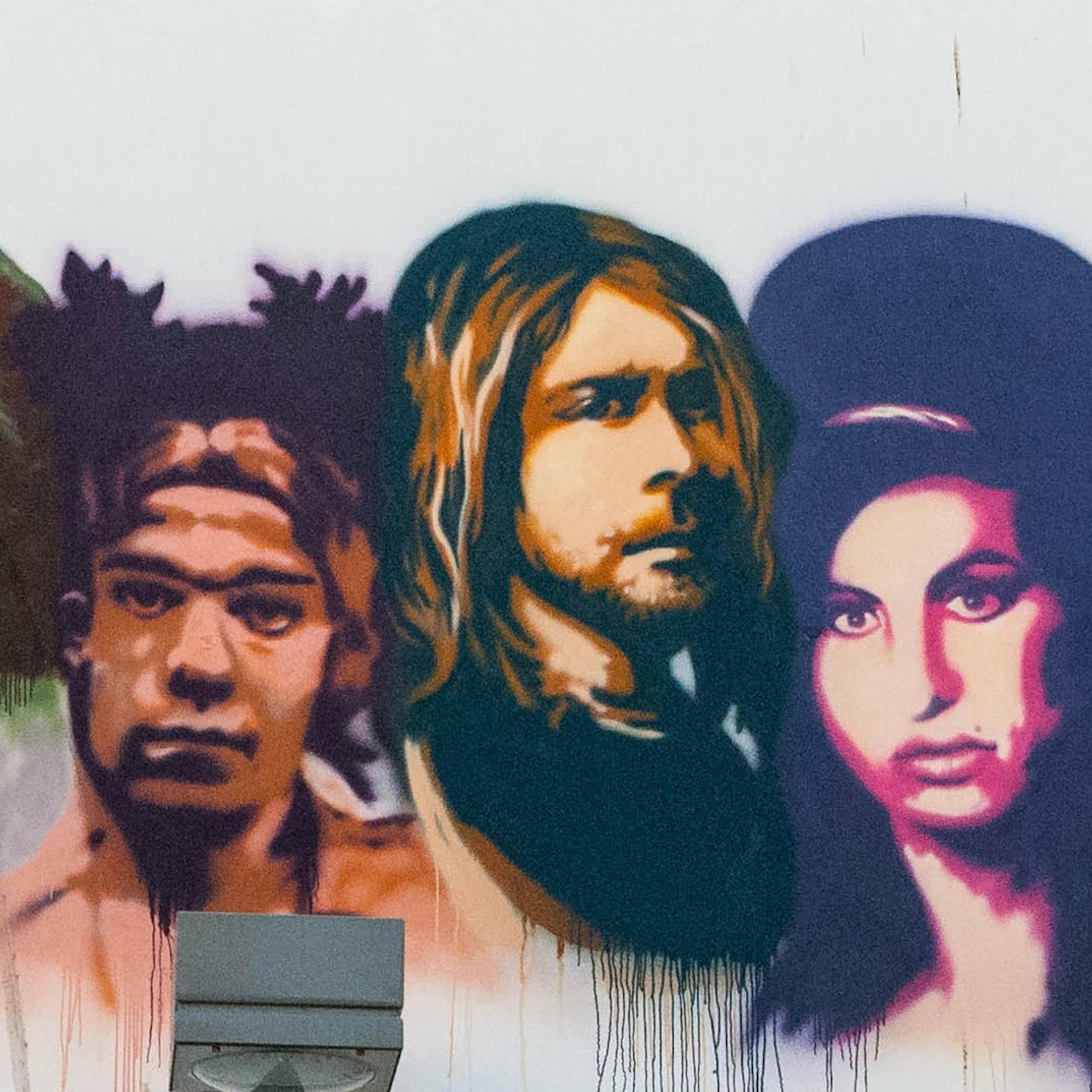 Photograph of graffiti mural of the busts of Brian Jones, Jimi Hendrix, Janis Joplin, Jim Morrison, Jean-Michel Basquiat, Kurt Cobain and Amy Winehouse