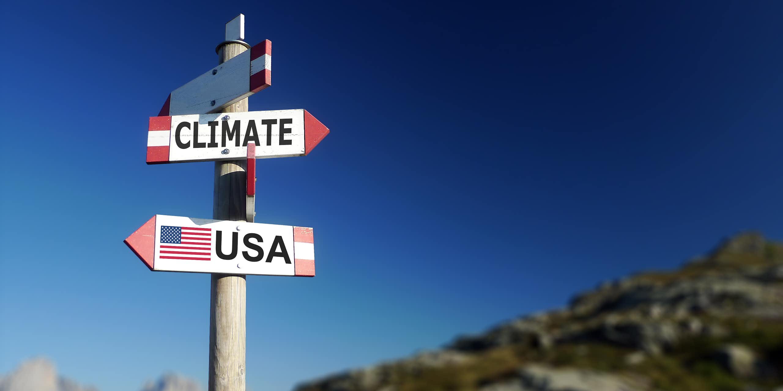 Road sign pointing to climate and USA in two different directions